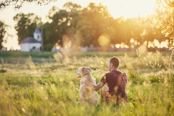 Man with his dog at sunset