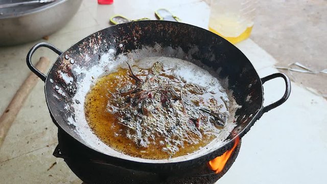 Close-up on dead frogs plunged into boiling oil for cooking ( close up )