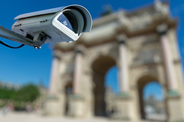 security CCTV camera or surveillance system with ancient monument on blurry background