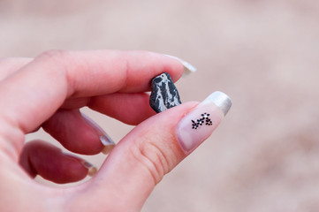 Woman's hand holding little stone