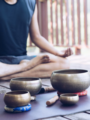 Yoga man with singing bowl for maditation