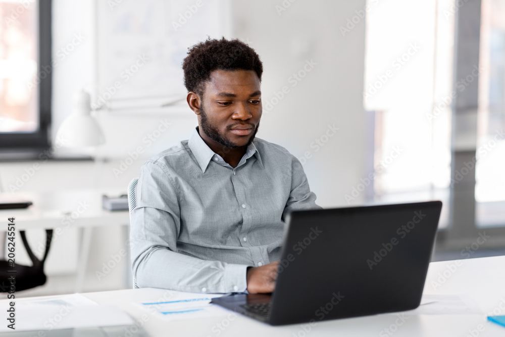 Canvas Prints business, people and technology concept - african american businessman with laptop computer working at office