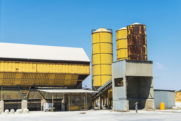 Obraz premium Yellow silos in an abandoned oil refinery in Sicily, Italy