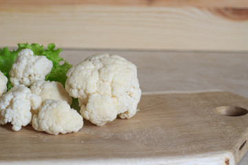Cauliflower on a wooden background. Close-up. Copy space.