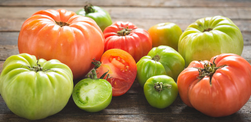 Fresh organic tomatoes on wooden table 