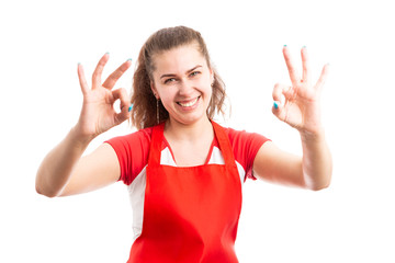 Woman supermarket worker making ok gesture.