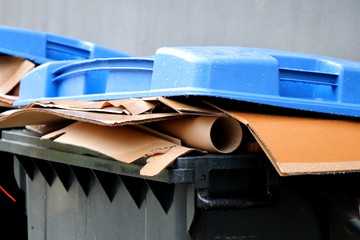 Blue dustbin with paper trash. Paper waste separation. Recycling in Germany