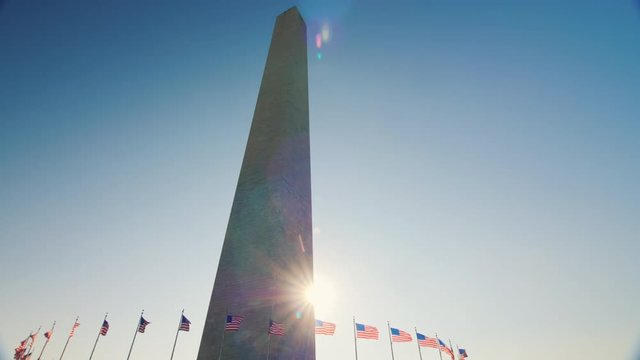 Static shot: Sunlight shines because of the Washington Monument, DC.