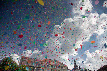confetti falling during a festival or carnival in the city