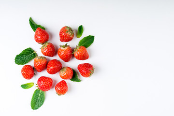 Fresh berries on white background, top view. Strawberry and mint leaf, flat lay. Summer background