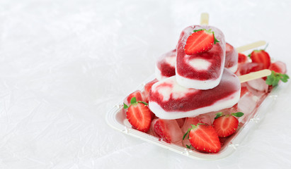 Strawberry vanilla ice cream popsicles on the white background with copy space.