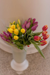 the red and yellow tulips in a vase