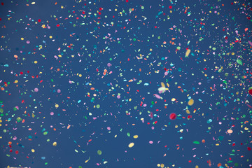 confetti falling during a festival or carnival in the city - obrazy, fototapety, plakaty
