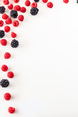 Frame isolated of Composition of fresh summer fruit, raspberries and blackberries on white background. Mediterranean diet with varied summer fruits. Stock photo. Top View
