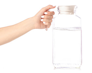 A decanter jug with water in hand on a white background isolation