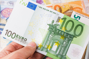 Euro banknote in a man's hand. The currency of the European 