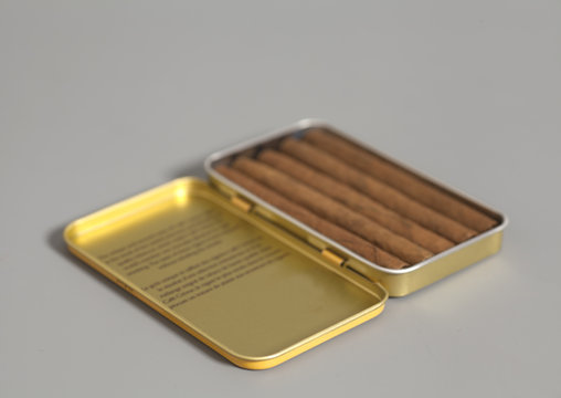 Open metal cigar box and cuban cigars