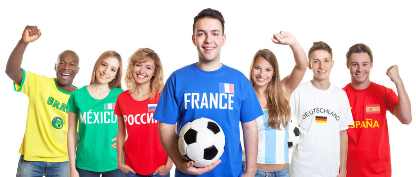 Cheerful french soccer fan with ball and fans from other countries