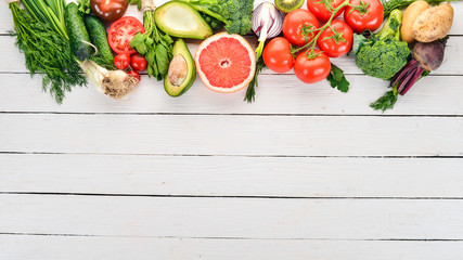 Healthy food. Vegetables and fruits. On a white wooden background. Top view. Copy space.