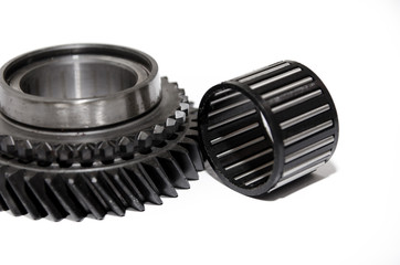 A gear wheel or pinion is a basic part of a gear train in the form of a disc with teeth on a cylindrical or conical surface meshing with the teeth of another gear