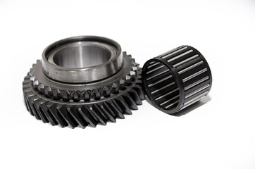 A gear wheel or pinion is a basic part of a gear train in the form of a disc with teeth on a cylindrical or conical surface meshing with the teeth of another gear