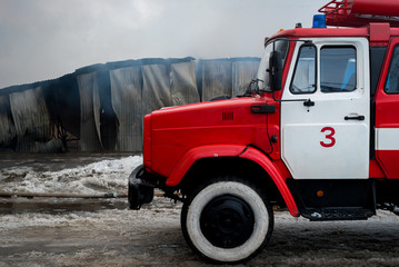 Chernivtsi / Ukraine - 03/19/2018: Fire Engine with sirens and blue lights with fire on background.