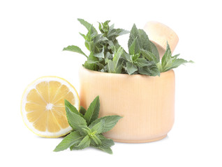 Bunches of fresh mint in a mortar with lemon. isolated