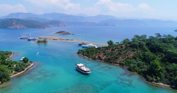 Amazing aerial view of picturesque gulf with crystal clear blue water. Flat island, Turkey. 4K.