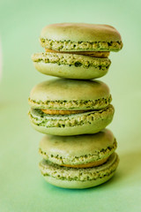 Concept sweets, enjoyment of the senses. Close up of French macaroons on a colorful background. Shallow depth of focus.