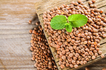 Raw red lentils on a wooden board. Superfood.
