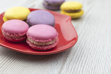 Macaroons on the red plate.