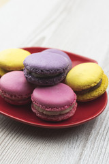 Macaroons on the red plate.