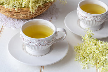 Two cups of herbal tea with fresh elder flowers