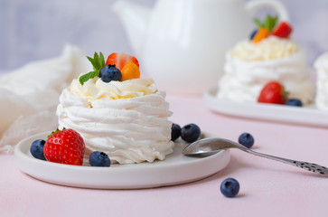 Meringue, Pavlova cake with strawberries, blueberries and mint
