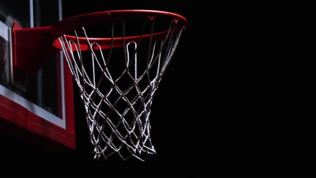 Close up of a swoosh through the net of a basketball hoop