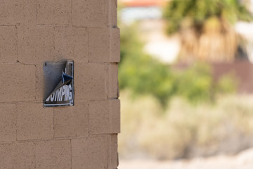 Weathered No Dumping Sign on Building