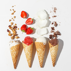 A set of ice cream in a horn with different ingredients. Sunlight. Isolated on white background. Procurement for Design