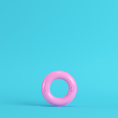 Yellow inflatable ring on bright blue background in pastel colors