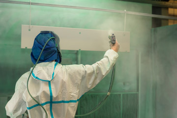 Man spray painting in protective clothing