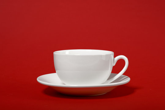 one simple coffee cup on red color background, closeup photo