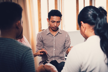 Christians  and Bible study concept. Group of discipleship Studying the Word Of God in church and Christians holding each others hand praying together