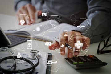 Healthcare costs and fees concept.Hand of smart doctor used a calculator for medical costs in modern hospital