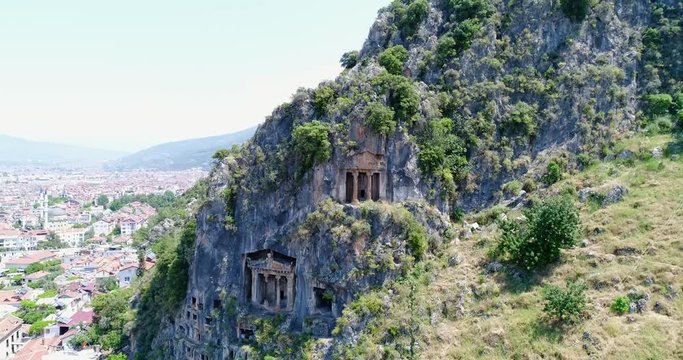 Aerial. Ancient Lycian rock-cut tombs, Fethiye, Turkey. 4K.