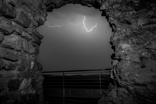 Thunderstorm through old stone arch