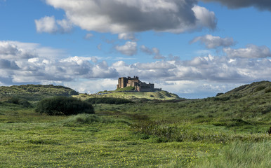 Fototapeta premium Bamburgh Castle view with blue sky and clouds