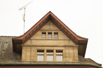 window on the roof of the building and antenna for television