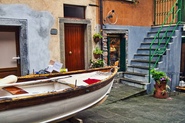 Fototapeta na wymiar Rowboat dry docked inside Cinque Terra village of Riomaggiore. (Italy).