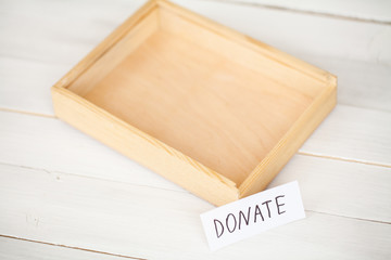 Donations and Charity. Donation Concept. A Donation Box on the White Background. Inscription Donate