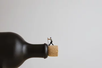 Zelfklevend Fotobehang Closeup of a miniature worker opening a bottle © kirill_makarov