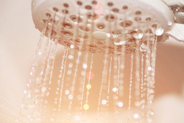 Wet faucet in the shower, water flows from the shower
